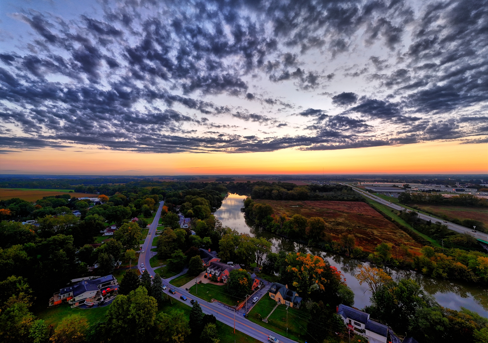 An aerial view of a rural area captured by a drone at sunset.