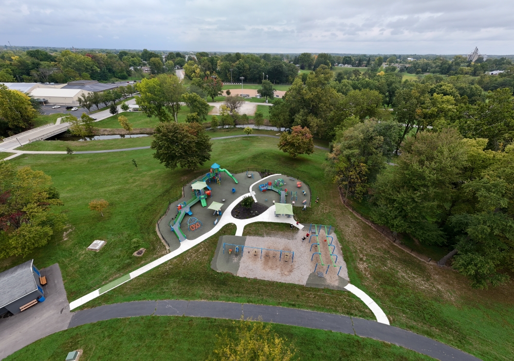 An aerial view of a playground in a park captured by a drone.