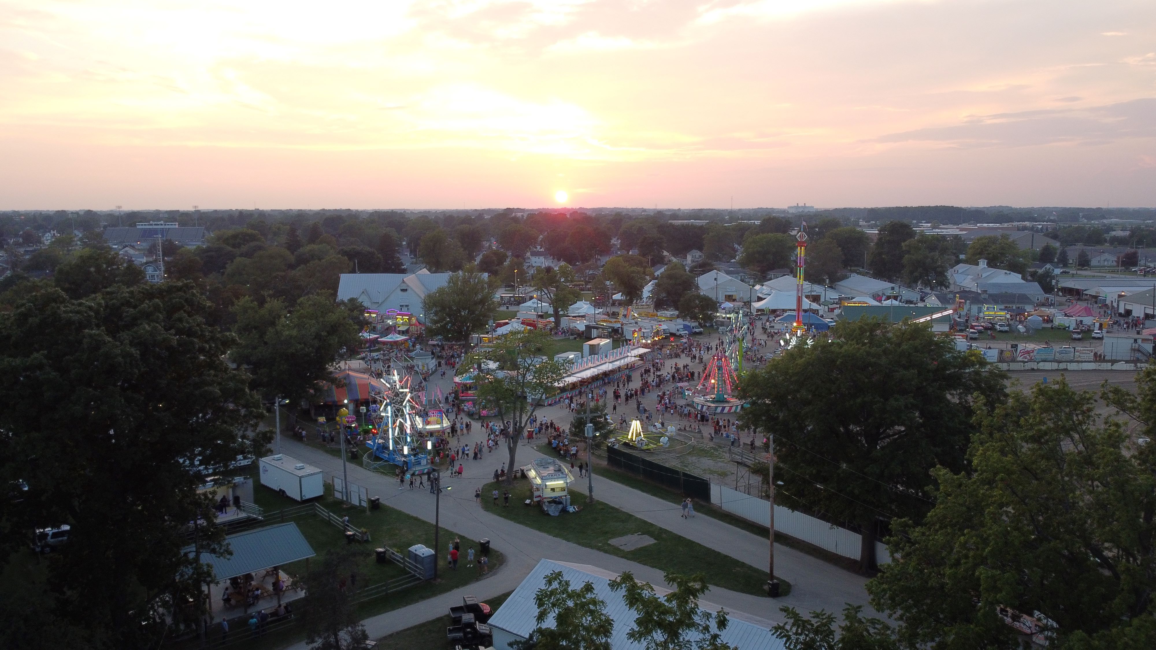 A captivating sunset view of the Seneca County Fair carnival, filled with vibrant lights and joyful rides.