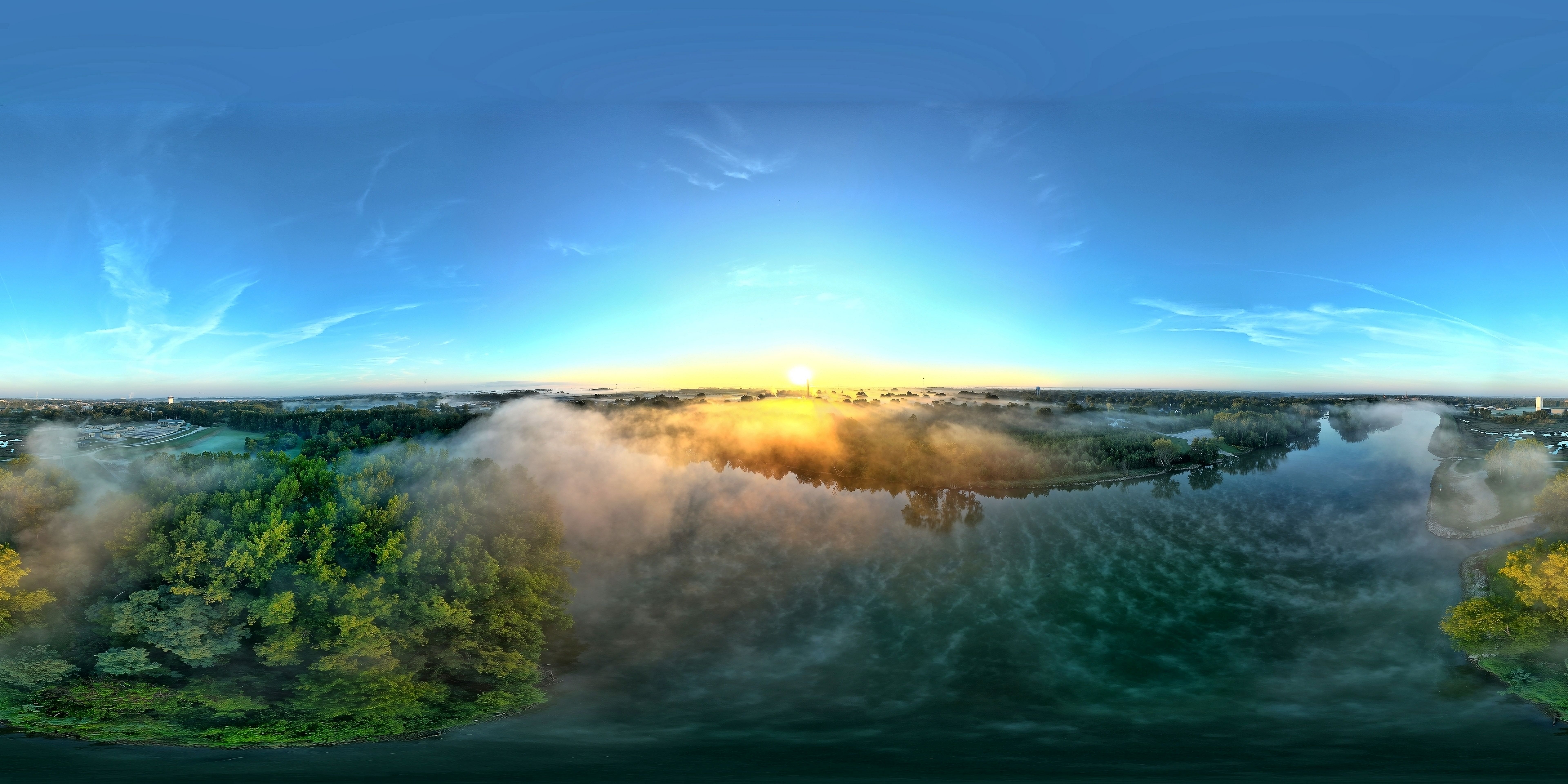 Breathtaking drone-captured 360 panorama of sunrise reflecting on a picturesque lake.